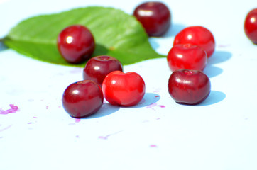 Red ripe cherries  on blue background, fruit pattern,photo