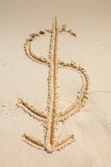 Dollar sign with a downward arrow drawn in the sand