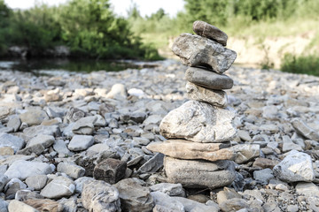 Fototapeta na wymiar stone tower on a mountain river