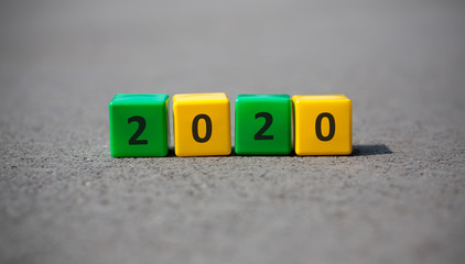 Diversed in color wooden blocks with black text on grey asphalt