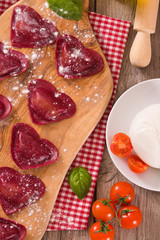 Red heart ravioli with tomato, mozzarella and basil. 