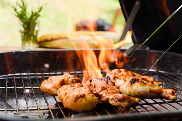 Roasted chicken drum stick, chest and sirloin beef with flame on charcoal stove