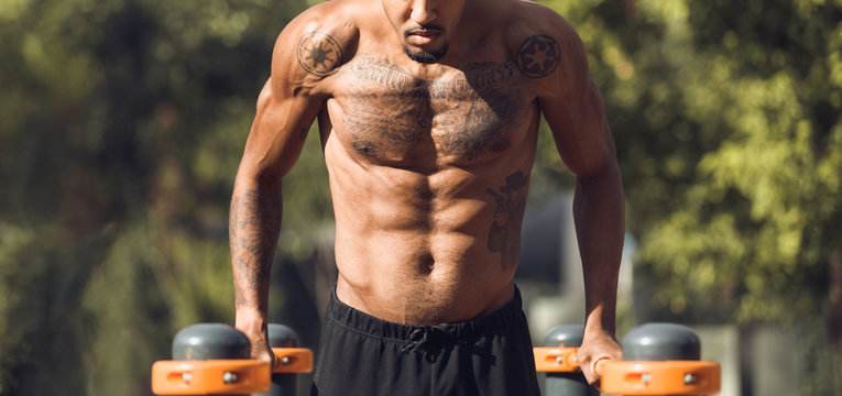 Shirtless Guy Doing Push Ups On Parallel Bars