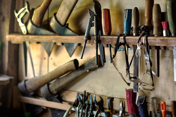 Old tools for carpentry work, hanging on rack. Horizontal orientation