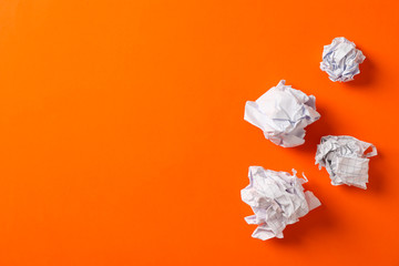 Flat lay composition with crumpled paper balls on color background, space for text