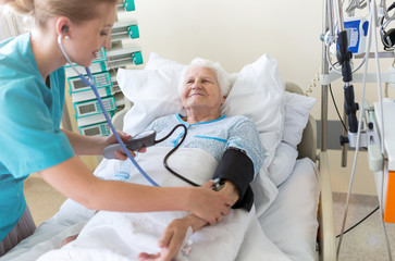 Senior patient and nurse in hospital