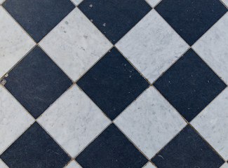 Fototapeta na wymiar Black and white wintage checkered floor tiles.