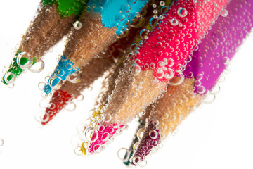 colored pencils in mineral water
