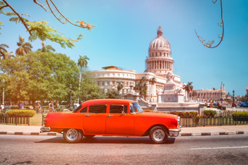 Antique american car next to the Capitol in Havana
