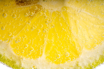 lemon slice  with bubbles in mineral water 