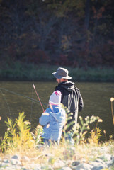 A Father and Daughter Fishing in a Lake on a Fall Day