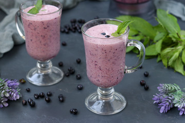 Nutritious cocktail with yogurt and blueberries located in glasses on a dark background, Healthy eating
