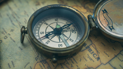 Fototapeta na wymiar Vintage Bronze Compass On Old World Map