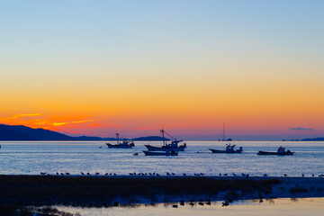 Anchored sea fishing boat.  sunset and fishing boat.