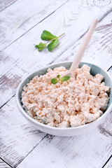 Cottage cheese of baked milk against the white wooden background