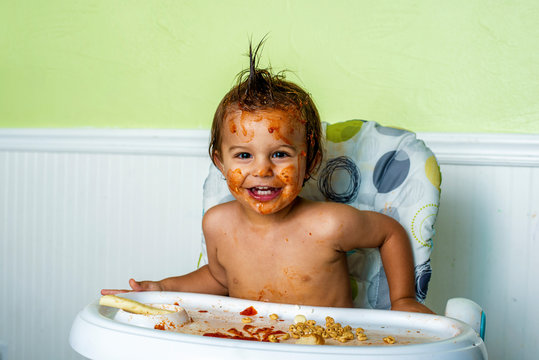 Little boy making a mess while eating