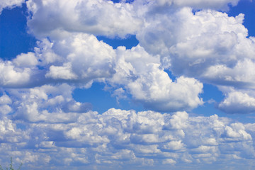 white fluffy clouds in blue summer sky 