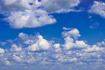 white fluffy clouds in blue summer sky 