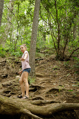 Naklejka na ściany i meble Tween Teen Girl with Bun Hiking Climbing up Rooted Trail in North Georgia Mountains
