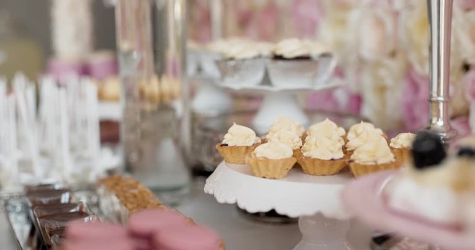 Cute candy bar with various cakes and candies. Wedding candybar.