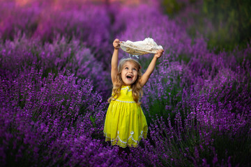 happy little girl is in a lavender field