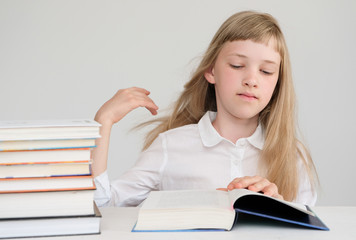 An excellent student looks for information in books.