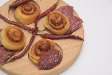 Naklejka na ściany i meble Salted dough. sliced sausage and chili peppers on a wooden board
