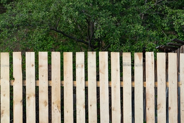 new wooden fence, high wooden fence of new boards