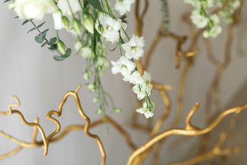 Decoration of the banquet hall, photo zone and wedding arch with eucalyptus leaves, hydrangea and eustoma in the wedding hall. Golden branches. Wedding floristry