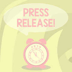 Word writing text Press Release. Business photo showcasing statement issued to newspapers giving information on matter Round Blank Speech Balloon in Pastel Shade and Colorful Analog Alarm Clock