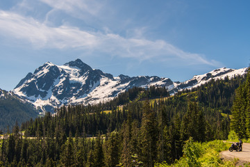 Fototapeta premium Mid-June Western Landscape of Mount Shuksan with Motorcyclist taken from Mount Baker Highway