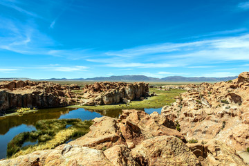 View of the Laguna Negra, Black lagoon Lake wedged between rock formations in Altiplano, Bolivia