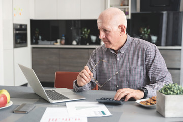 Fototapeta premium Pensioner counts money, tax calculation concept