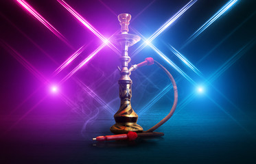 Hookah, smoke on a dark abstract background. Background of empty scenes with multicolored neon...