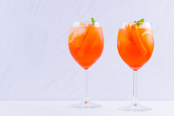 Cocktail Aperol Spritz with mint leaves on a white background. Italian cocktail aperol spritz on white background