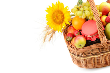 Food isolated on white background. A set of fruits in a woven basket. Free space for text.