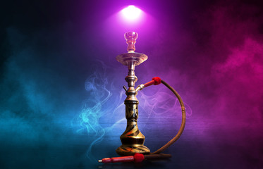 Hookah, smoke on a dark abstract background. Background of empty scenes with multicolored neon...