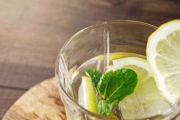 Close-up of a glass with a cocktail of lemon, mint and ice
