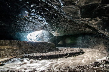 Icelandic Ice cave. Glaciel river running inside Icecave