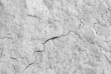 The texture of natural stone granite with small cracks. Background of natural stone gray. Texture with fine flaw.
