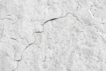The texture of natural white granite stone with cracks. Background of natural stone gray. Texture with a small crack.