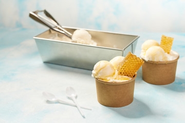 Spoon for   ice cream takes a little out of the package vanilla ice cream. Making ball of ice cream. Top view