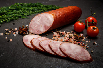 half of smoked ham sausage with dill and tomatoes
