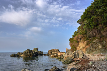 Rock and boulder on the coast of the Aegean Sea in Greece.
