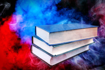 books stacked on top of each other and a colorful background