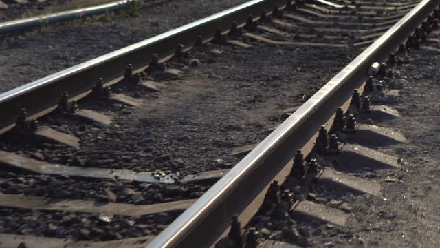 Railway rails and sleepers in summer sunny day. Close-up. Railroad track