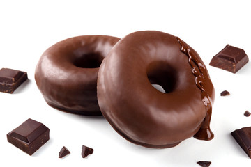 Delicious fresh chocolate donuts with pieces of chocolate on white background. Appetizing tasty...