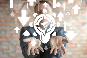 Leadership Business concept. Man uses on virtual screen of future and offers icons: light bulb with compas and arrows. © wladimir1804