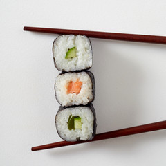 Food styling concept with three maki sushi rolls