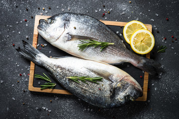 Raw dorado fish on black